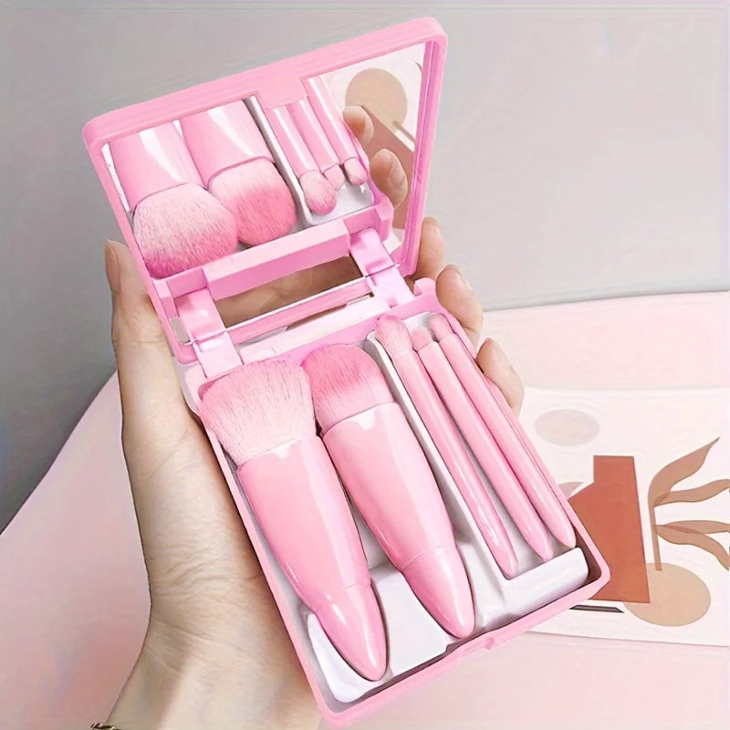Set of five portable mini makeup brushes with mirror, foldable travel cosmetics kit from amzzon.store for easy on-the-go beauty.