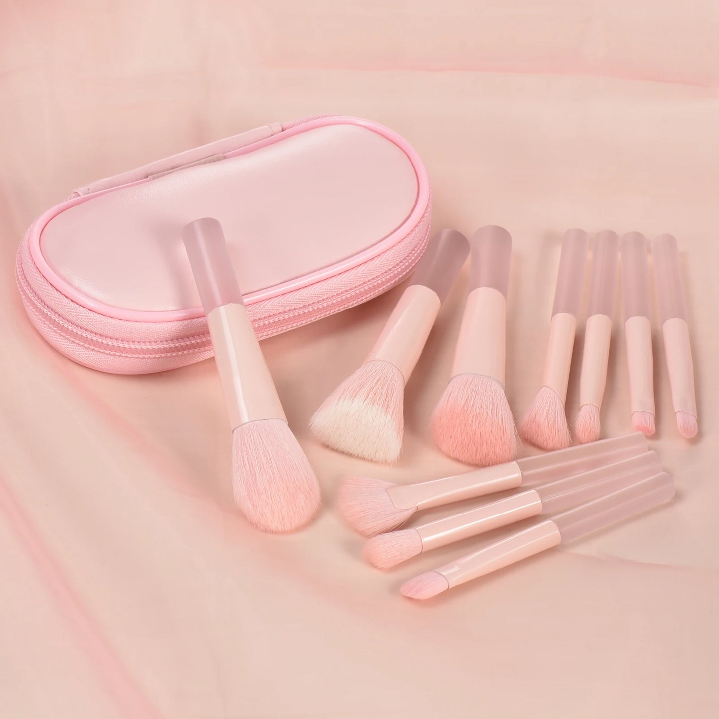 Pink mini makeup brush set with portable palm-sized brushes for professional makeup application, featuring soft bristles and a sleek design.