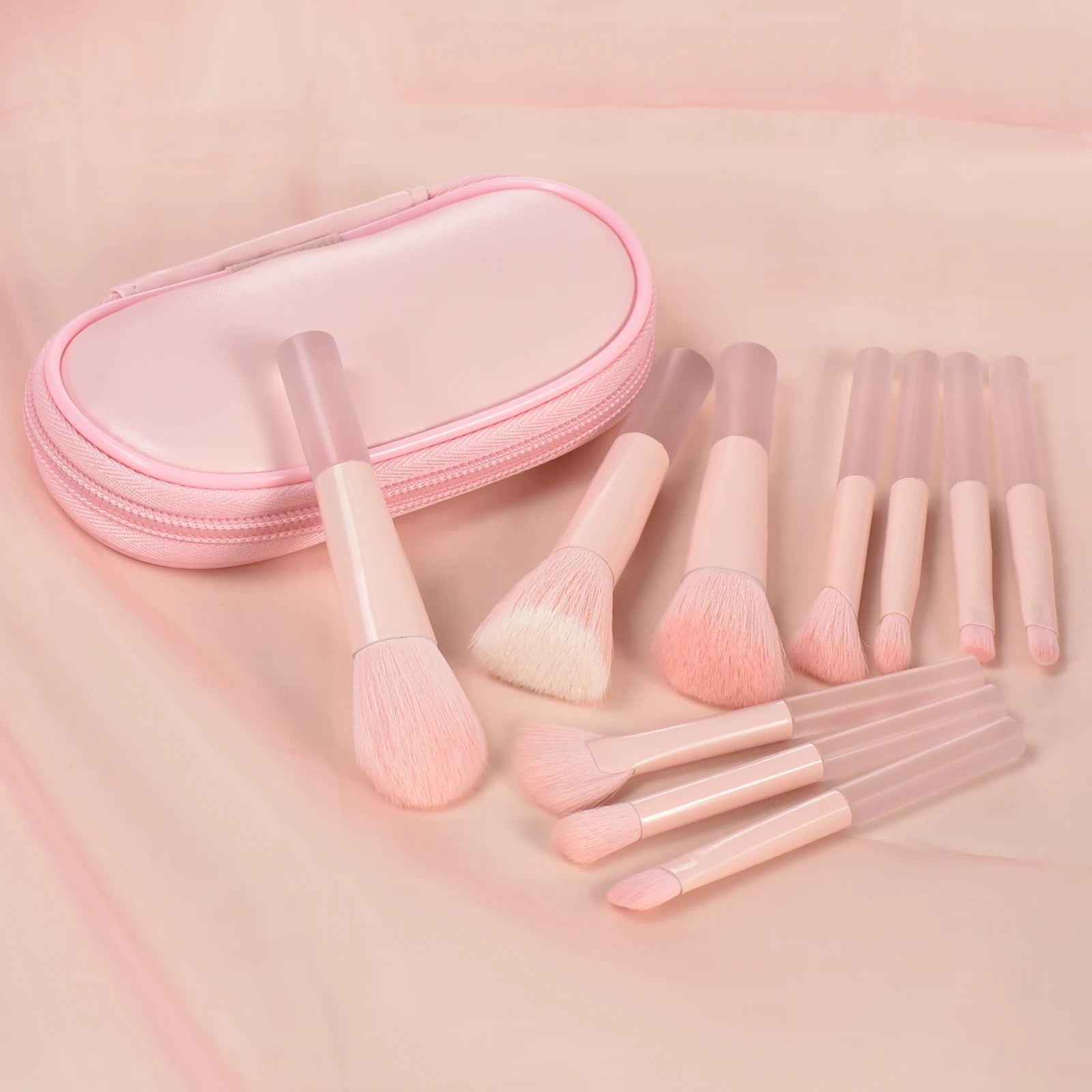 Pink mini makeup brush set with portable palm-sized brushes for professional makeup application, featuring soft bristles and a sleek design.