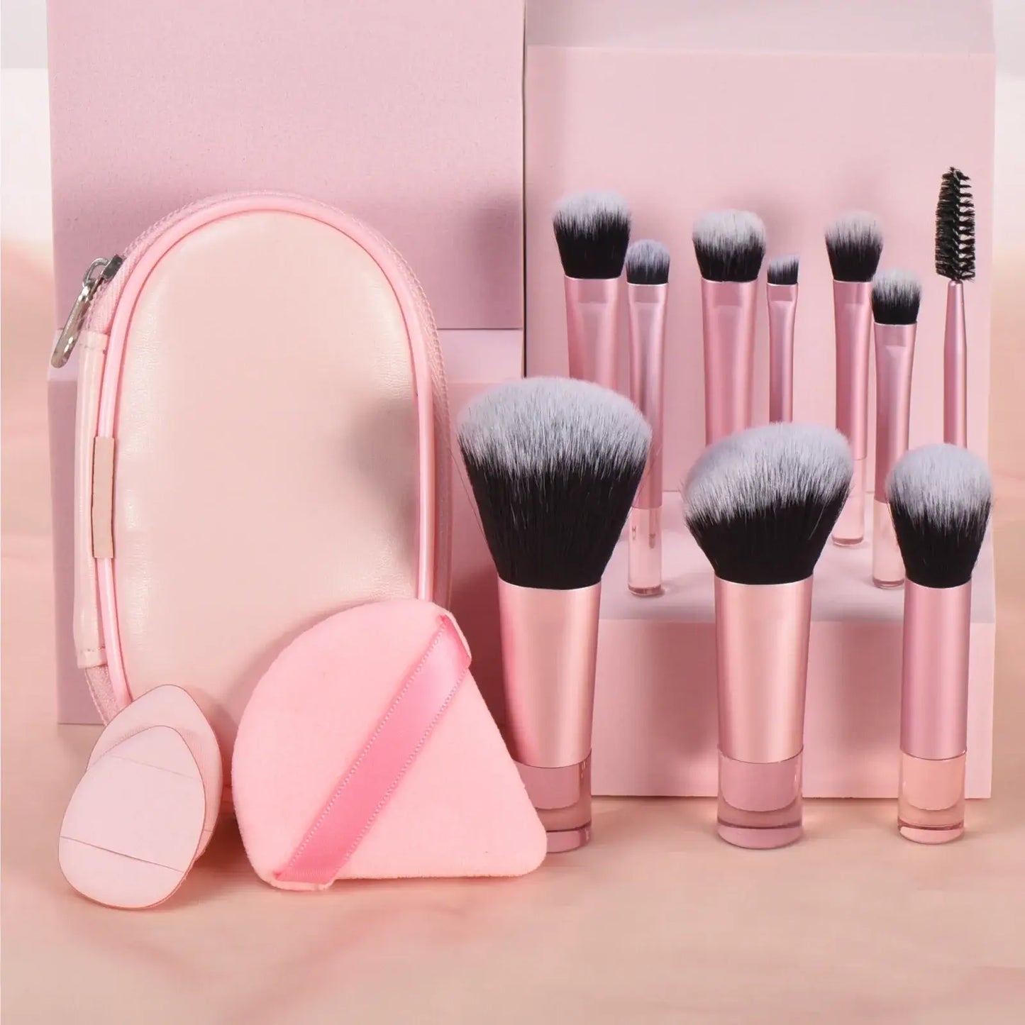 Pink mini makeup brush set with 10 portable palm-sized brushes and puffs, ideal for travel and professional makeup application