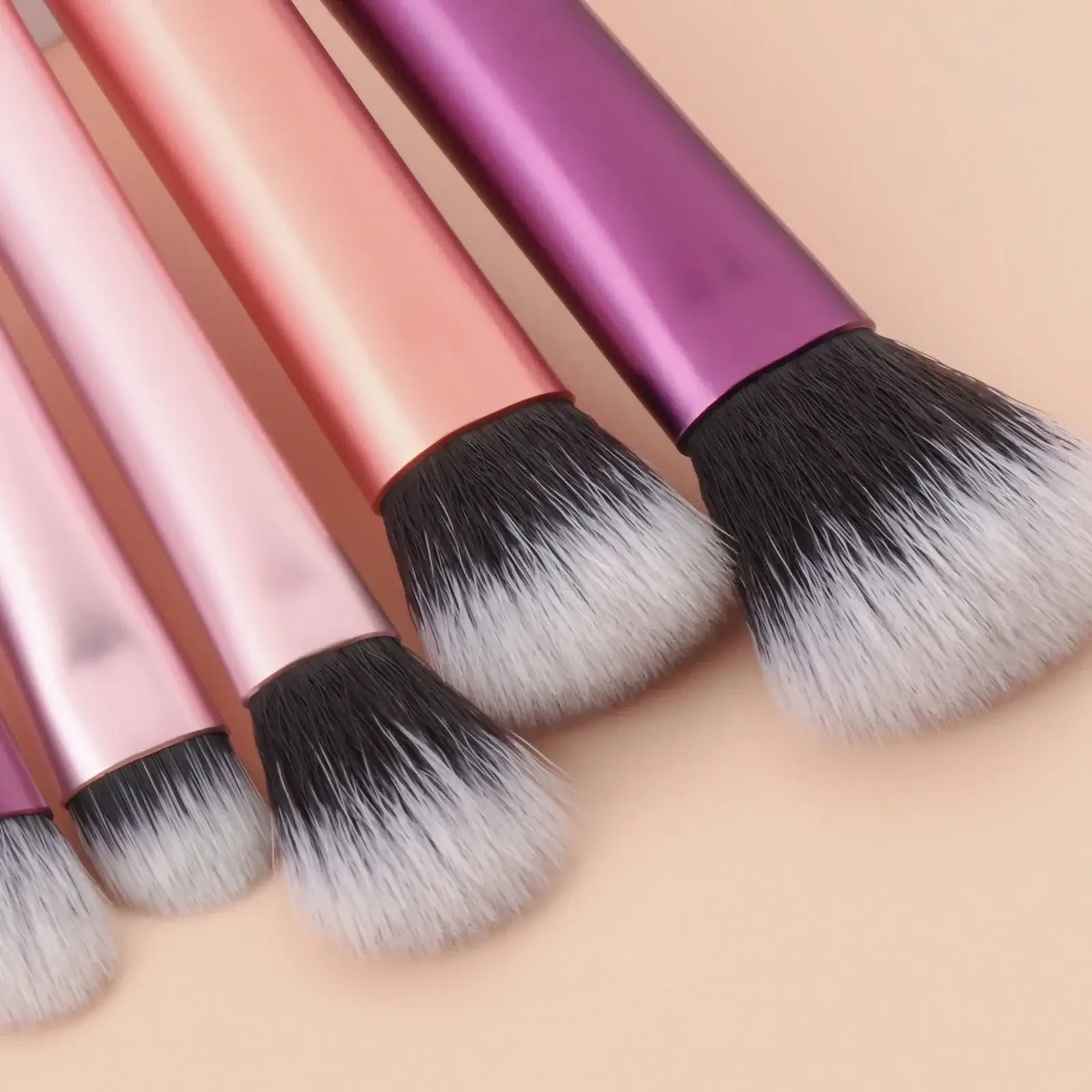 Pink mini travel makeup brush set with palm-sized professional brushes, including makeup puffs, by amzzonstore.