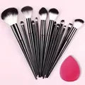 Set of 13 professional makeup brushes from amzzonstore including foundation, eyeshadow, blush, and blending brushes with soft fluffy bristles.