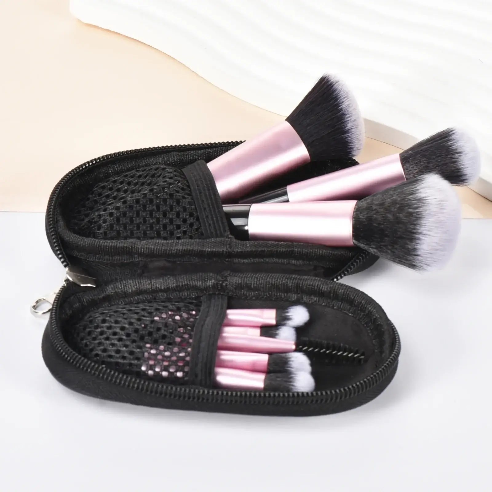 Pink mini makeup brushes set with portable palm-sized brushes and puffs, ideal for travel and professional makeup application.