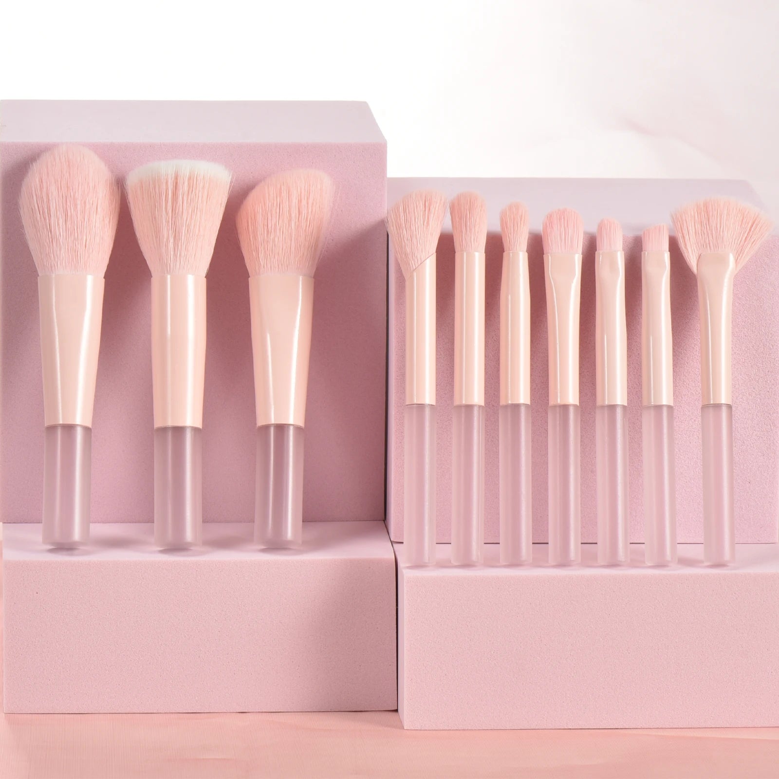 Set of 10 pink mini portable makeup brushes and puffs from Amzzonstore, ideal for travel and professional makeup application.