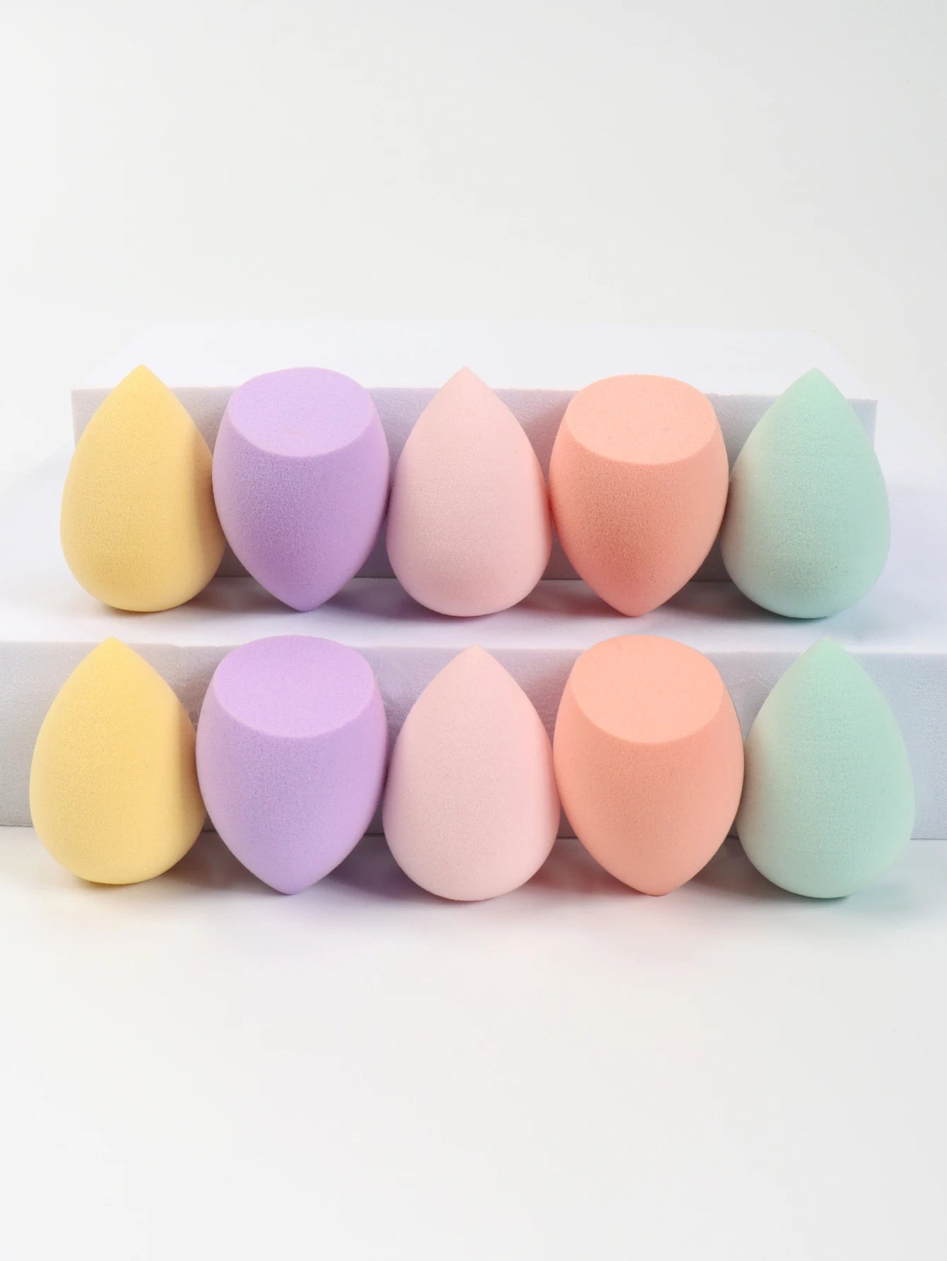Set of 10 mini makeup sponges by amzzonstore, perfect for applying foundation, concealer, and face cosmetics smoothly.