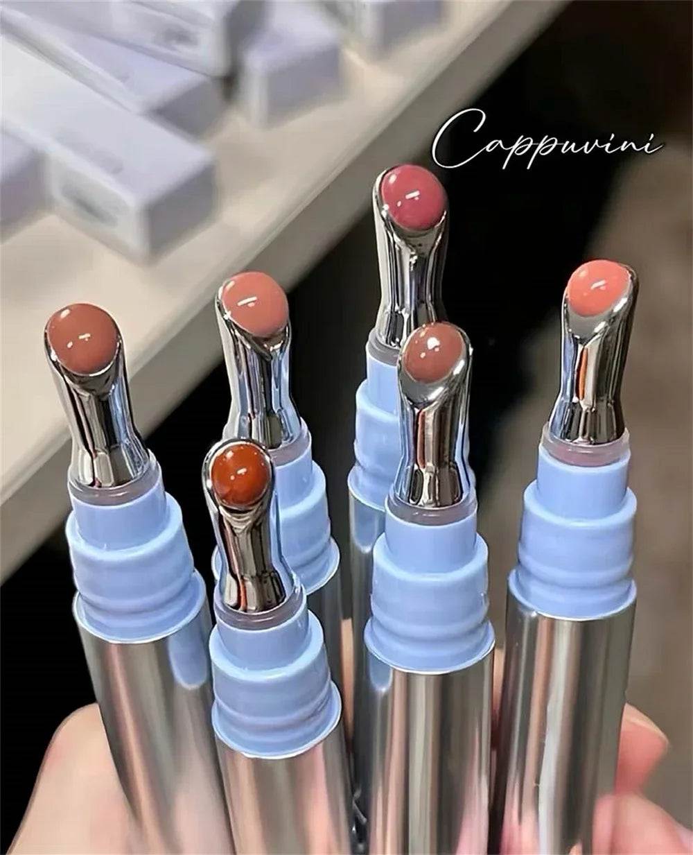 Metal Head Ice Diamond Essence Lip Tint from amzzonstore showing the glass lip gloss applicator with moisturizing and plumping properties.
