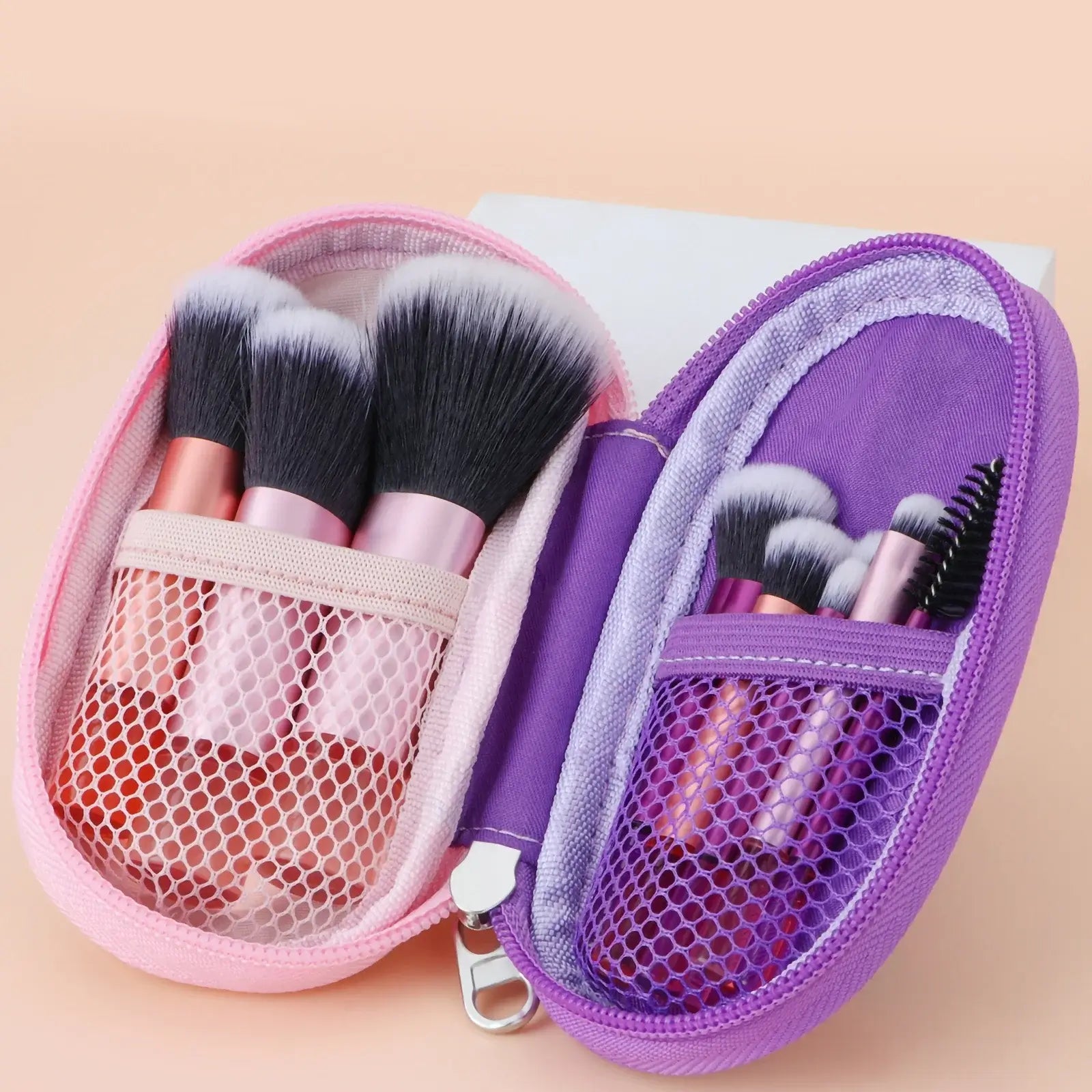 Set of 10 pink mini portable makeup brushes including puffs, ideal for travel and professional makeup application.