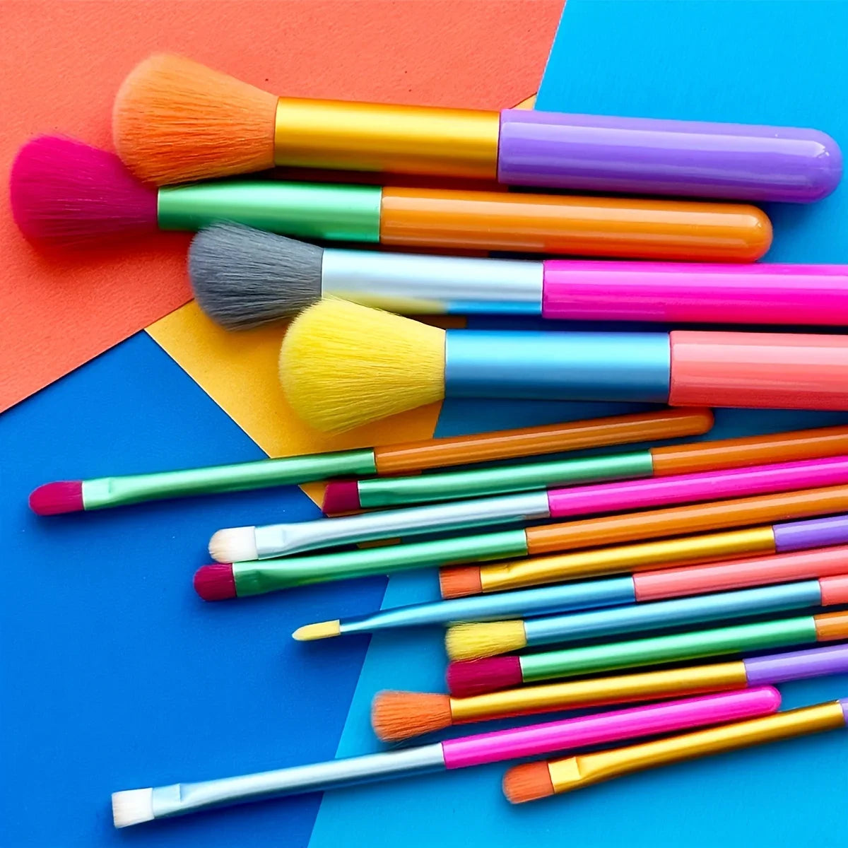 Set of 15 colorful makeup brushes including foundation, blush, concealer, eyeshadow, and blending brushes for professional makeup application.