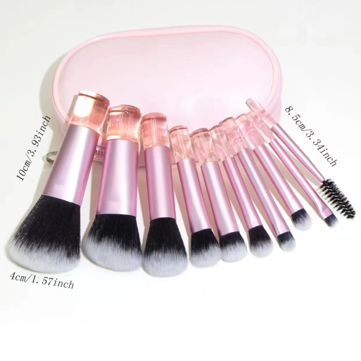 Set of 10 mini makeup brushes with pink handles and black ferrules, stored in a compact pink pouch for face and eye makeup application.