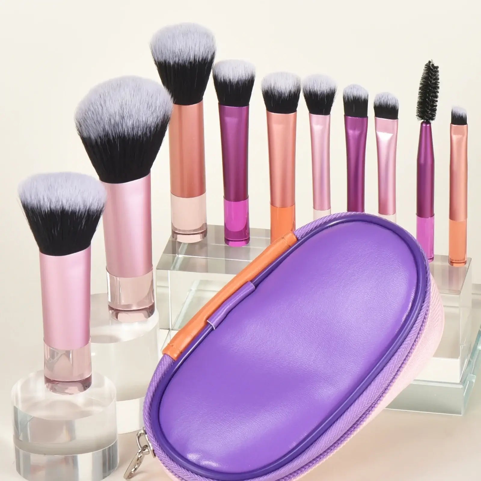Pink mini travel makeup brush set with palm-sized professional makeup tools and puffs, ideal for portable cosmetic application.