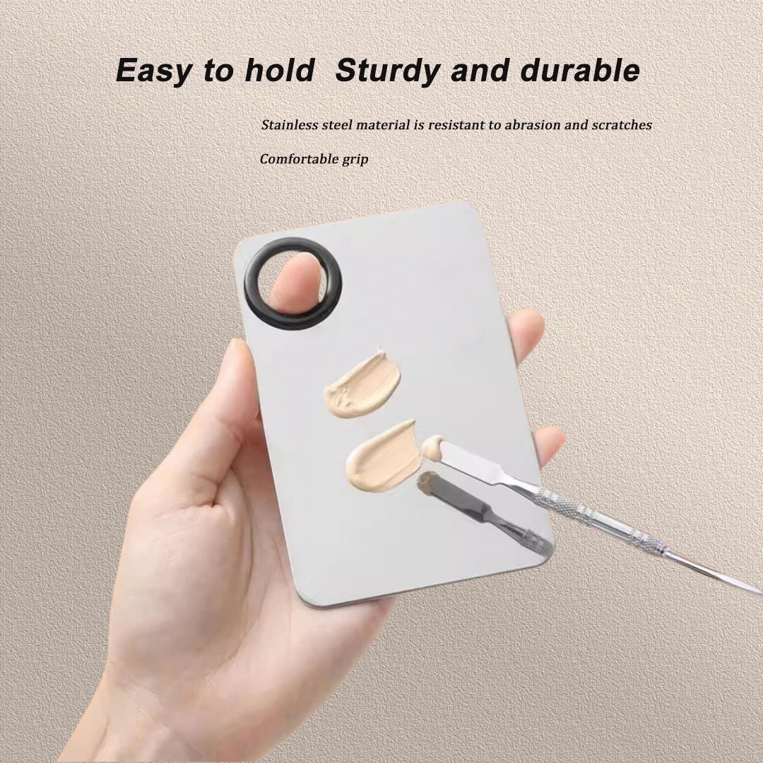 Stainless steel makeup mixing palette with spatula and mixing stick for foundation, lipstick, eye shadow, and beauty application.