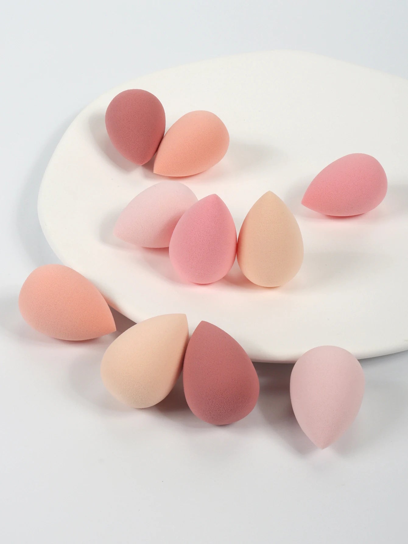 Set of 10 mini makeup sponges by amzzonstore, soft powder puffs for applying concealer, foundation, and liquid makeup smoothly.