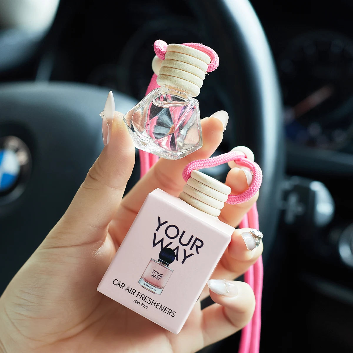 Amzzonstore car perfume air freshener hanging inside vehicle, keeps car interior smelling fresh and charming over time.