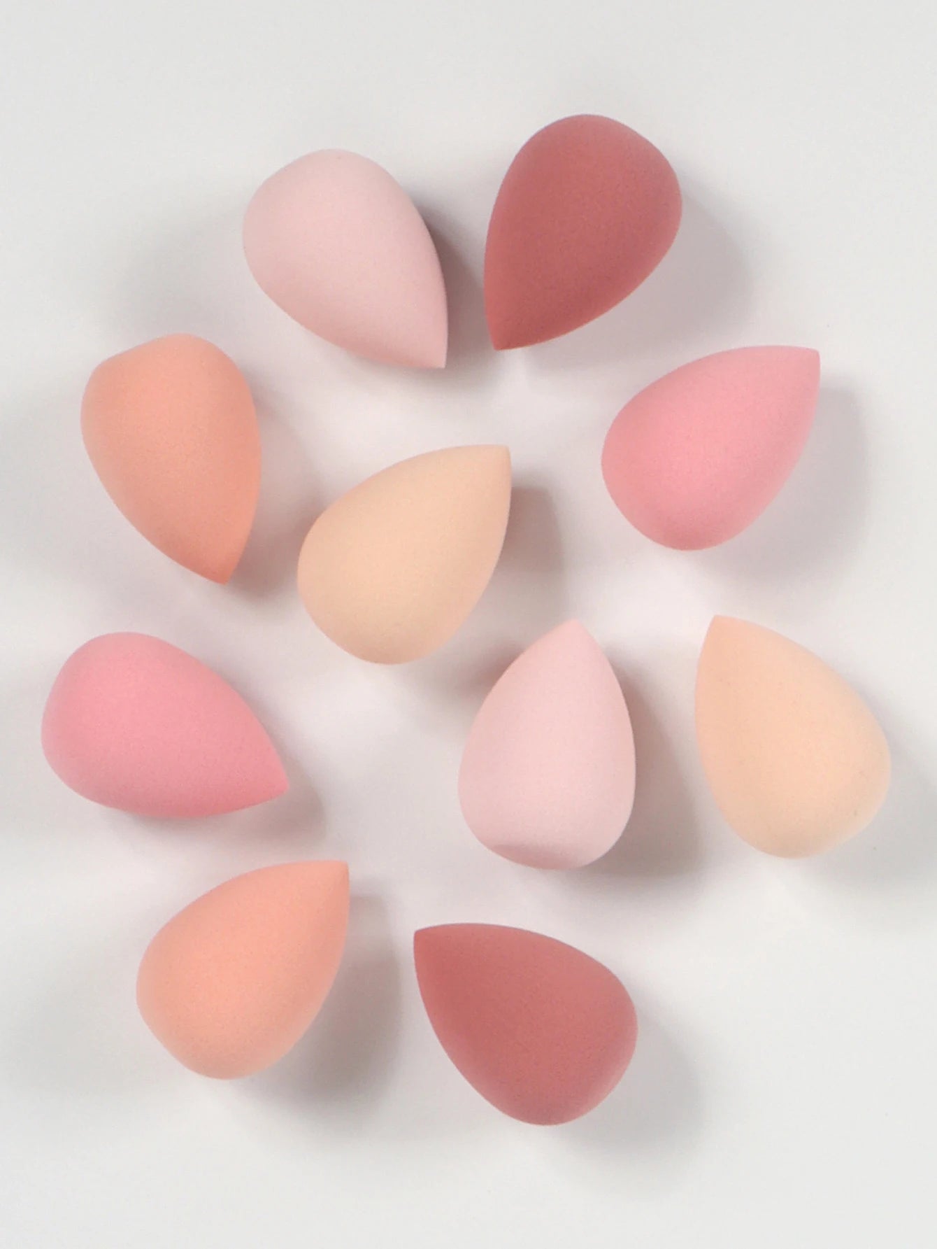 Set of 10 mini makeup sponges by amzzonstore, soft powder puffs for applying foundation, concealer, and liquid makeup smoothly.