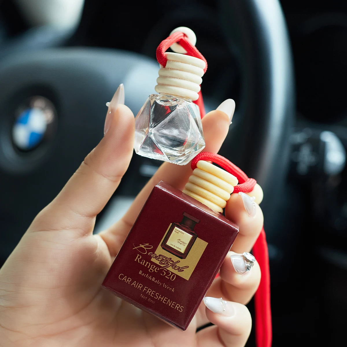 Amzzonstore car perfume air freshener hanging inside vehicle, enhances interior with long-lasting fresh and charming scent.
