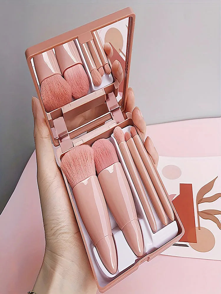 Set of five portable mini makeup brushes with mirror, foldable travel cosmetics kit from amzzon.store for easy on-the-go beauty.